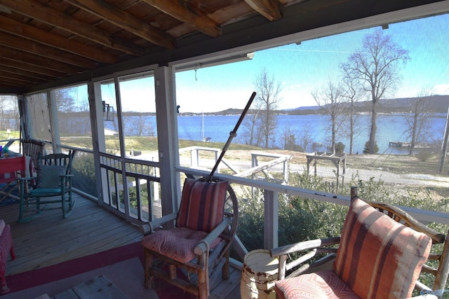 wooden terrace featuring a water view