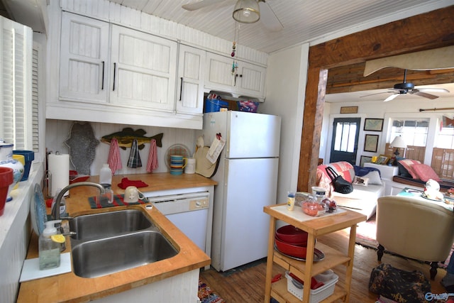 kitchen with wooden counters, dark wood-type flooring, white appliances, a ceiling fan, and a sink