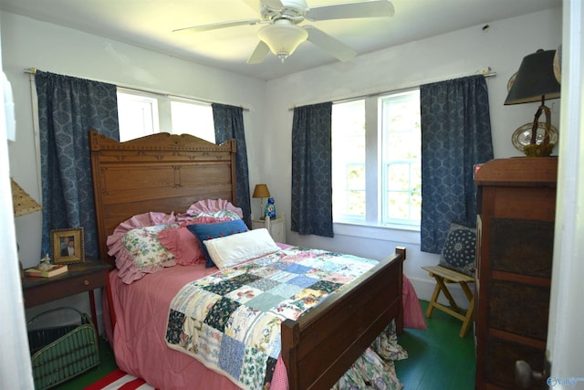 bedroom featuring multiple windows and ceiling fan