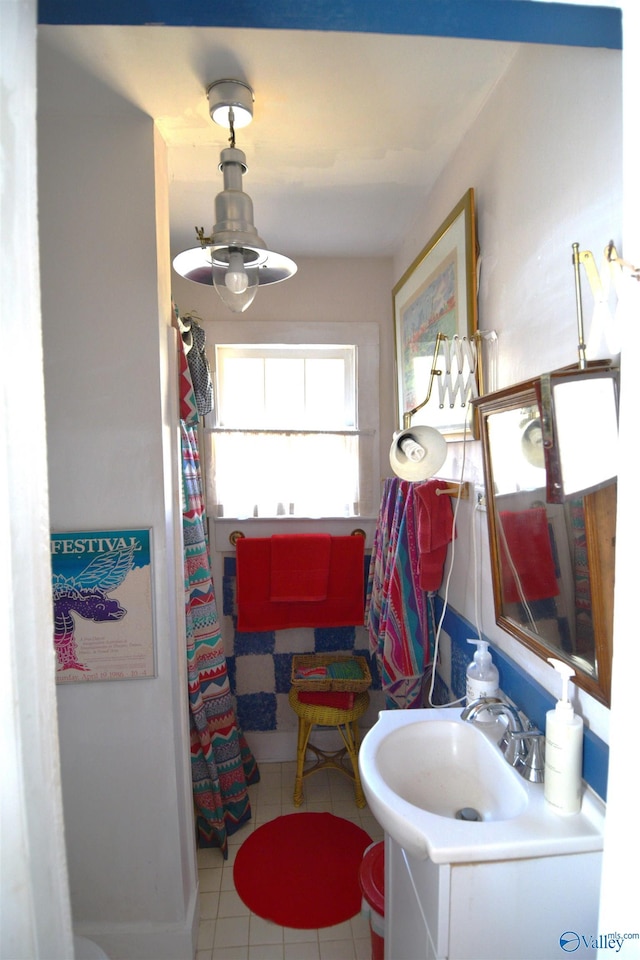 bathroom with a shower with shower curtain, vanity, and tile patterned flooring