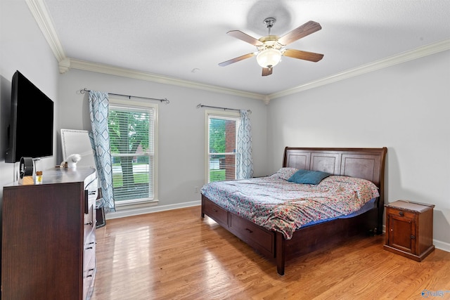 bedroom featuring light wood-style floors, ornamental molding, and baseboards