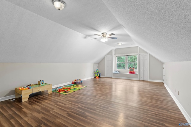 game room with a textured ceiling and wood finished floors