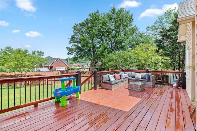 deck featuring a yard, outdoor lounge area, and a fenced backyard