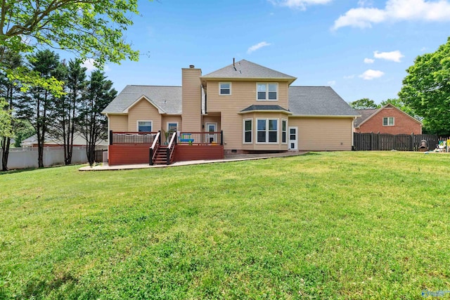 rear view of house with crawl space, a lawn, a chimney, a deck, and fence