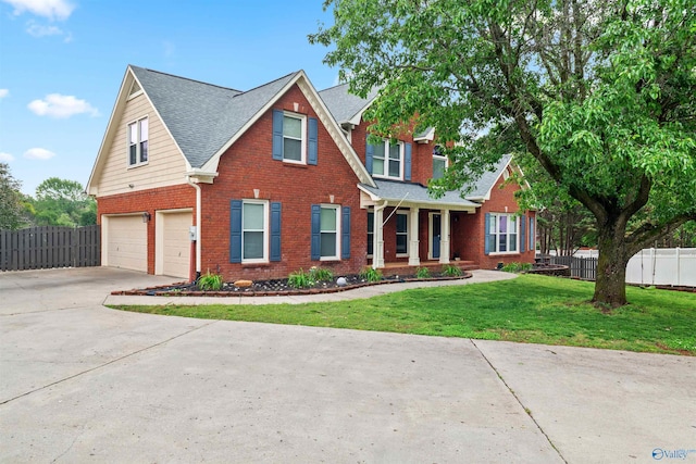 traditional-style house with fence, concrete driveway, an attached garage, and brick siding