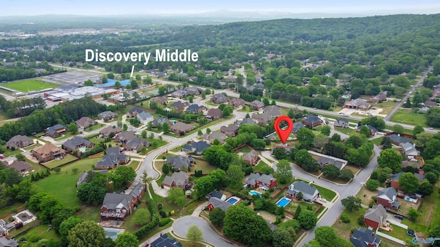aerial view featuring a wooded view and a residential view