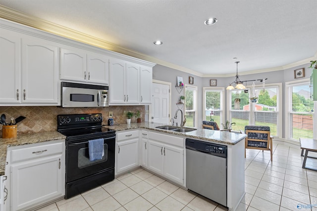 kitchen with a sink, stainless steel appliances, light tile patterned floors, a peninsula, and white cabinets