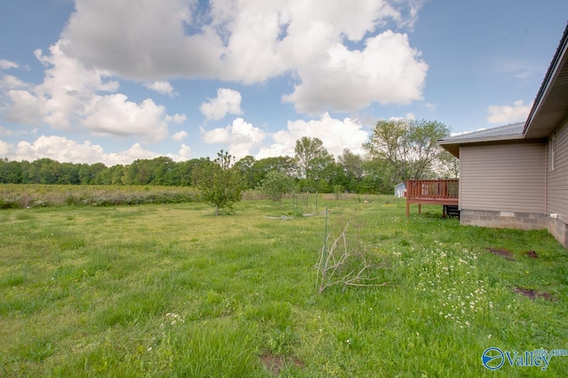 view of yard with a deck and a rural view