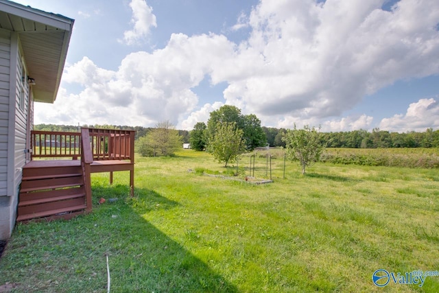 view of yard with a deck and a rural view