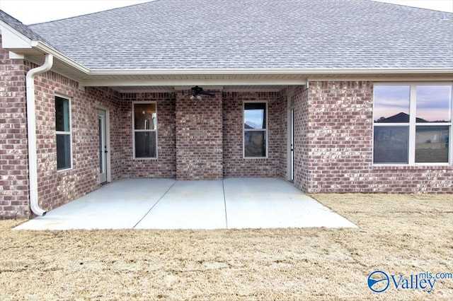 exterior space with ceiling fan and a patio area