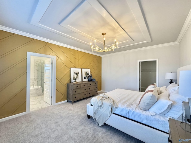 carpeted bedroom with a chandelier, attic access, ornamental molding, a spacious closet, and a tray ceiling