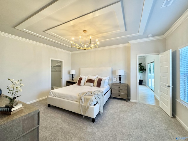 carpeted bedroom with a raised ceiling, a chandelier, a spacious closet, crown molding, and baseboards