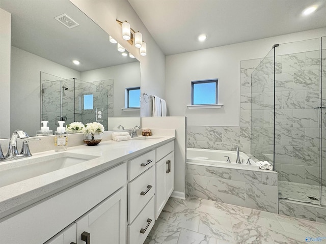 full bathroom featuring marble look tile flooring, a marble finish shower, a bath, double vanity, and recessed lighting