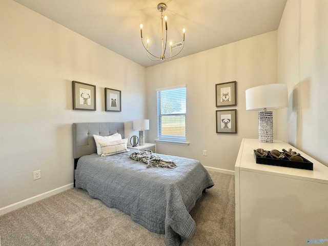bedroom featuring a chandelier, carpet, and baseboards