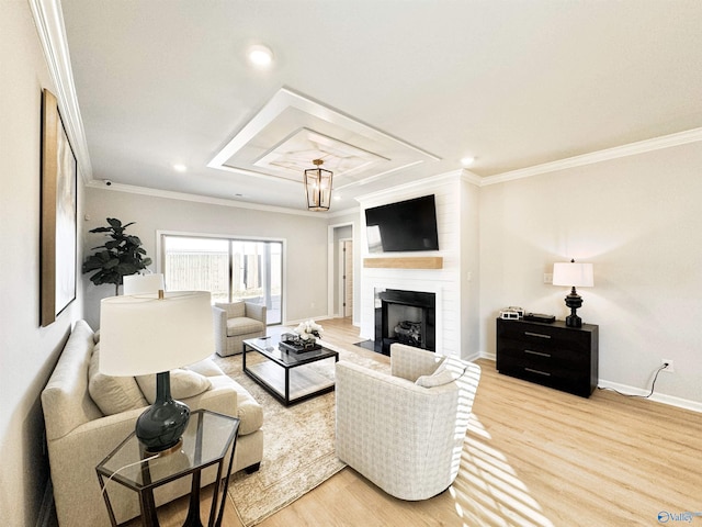 living room featuring crown molding, wood finished floors, baseboards, recessed lighting, and a large fireplace