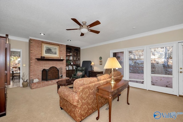 living room with a textured ceiling, light carpet, a brick fireplace, and ceiling fan