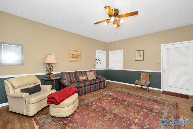 living room with ceiling fan and hardwood / wood-style floors