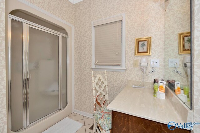 bathroom featuring vanity, tile patterned floors, and a shower with door