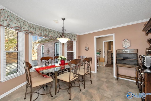 tiled dining space featuring ornamental molding and a textured ceiling