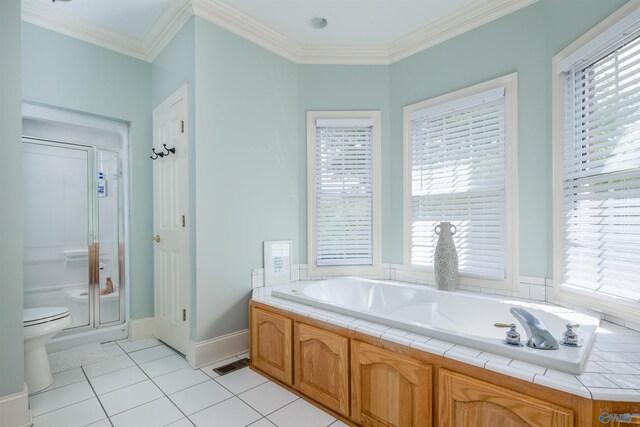 bathroom featuring toilet, tile patterned floors, and a healthy amount of sunlight