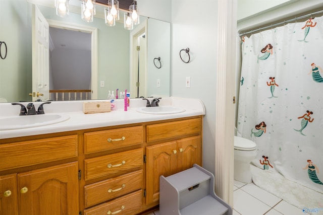 bathroom with tile patterned flooring, toilet, and double sink vanity