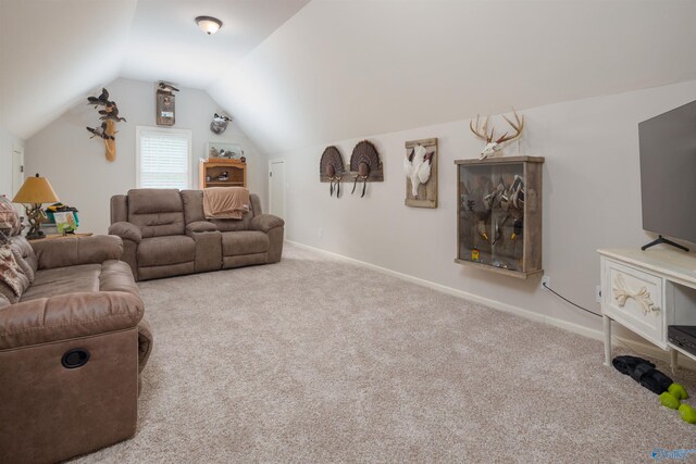 carpeted living room featuring vaulted ceiling