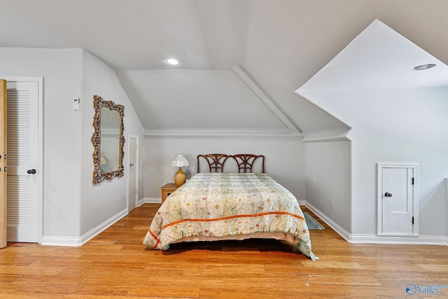 bedroom featuring vaulted ceiling and light hardwood / wood-style floors