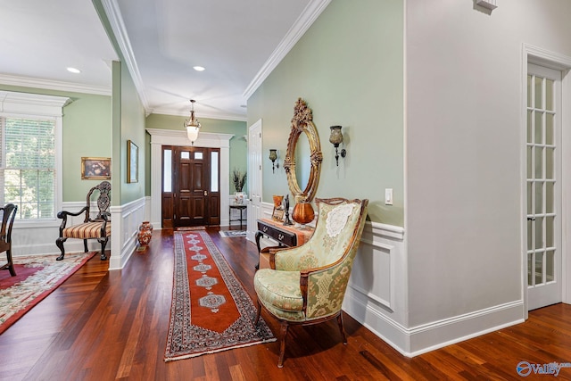 foyer entrance with ornamental molding and dark hardwood / wood-style floors