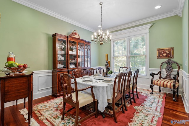 dining space featuring crown molding, a chandelier, and hardwood / wood-style flooring