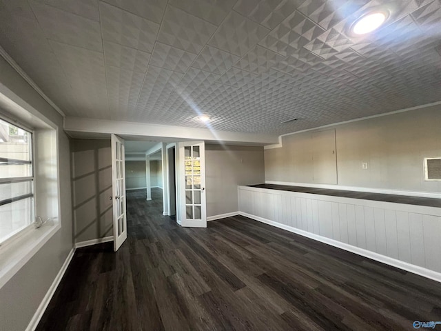 spare room with dark wood-type flooring and ornamental molding