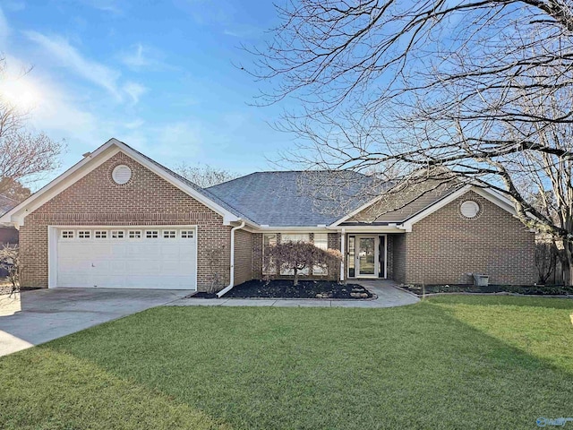 view of front of property with a front yard and a garage