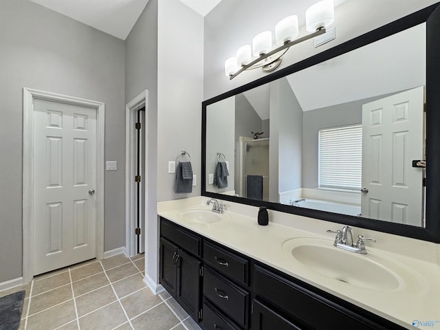 bathroom with plus walk in shower, vaulted ceiling, tile patterned floors, and vanity