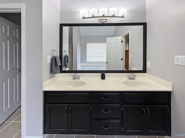 bathroom with vanity, tile patterned flooring, and a tub