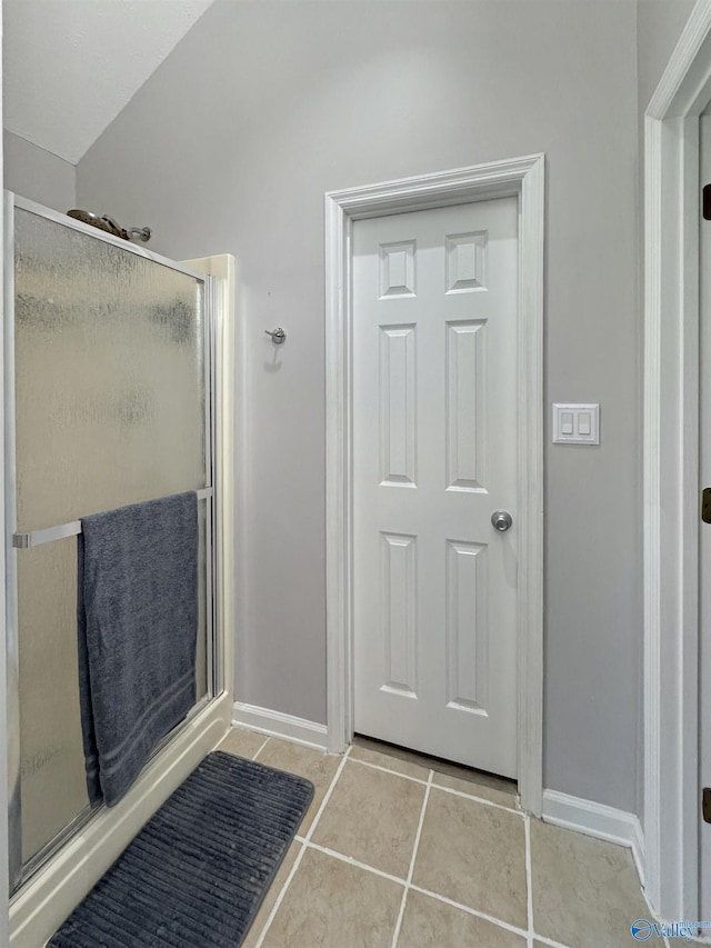 bathroom featuring a shower with door and tile patterned floors