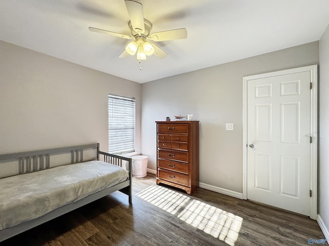 bedroom featuring ceiling fan and dark wood-type flooring