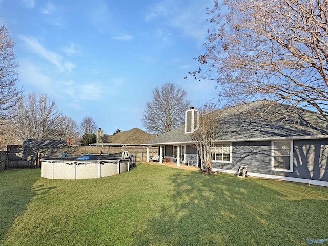 view of yard featuring a covered pool