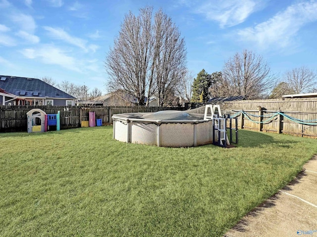 view of yard with a covered pool