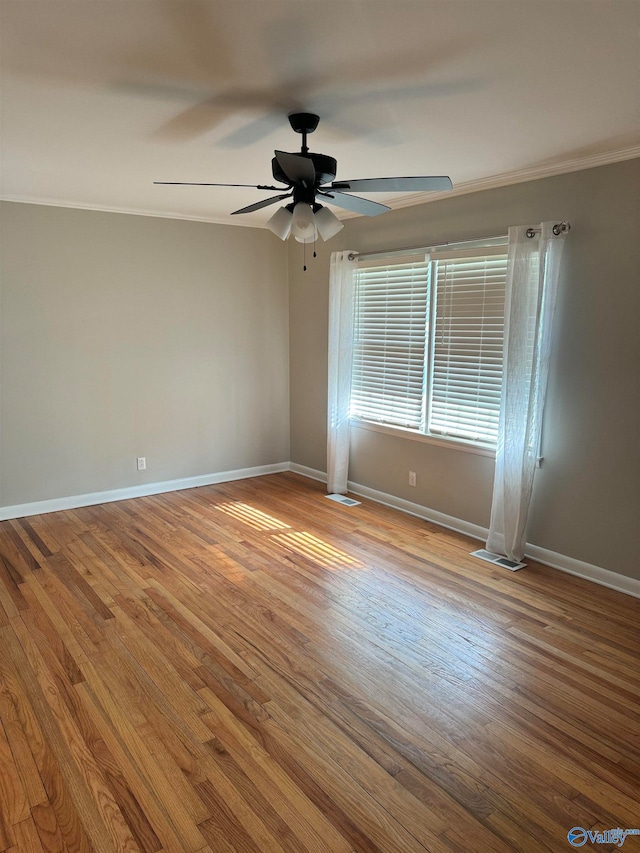 unfurnished room featuring ceiling fan, ornamental molding, and light hardwood / wood-style flooring