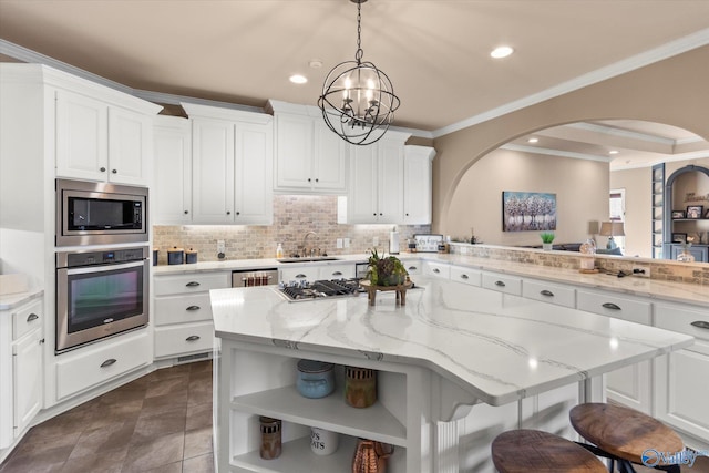 kitchen featuring stainless steel appliances, white cabinets, a sink, and decorative backsplash