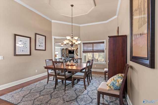 dining room featuring baseboards, ornamental molding, and wood finished floors