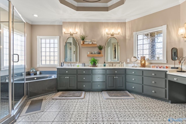 bathroom with double vanity, ornamental molding, a sink, and a bath