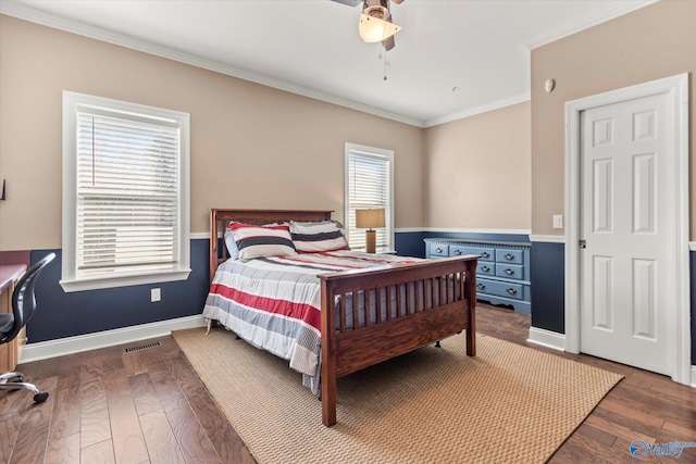 bedroom featuring baseboards, visible vents, a ceiling fan, ornamental molding, and hardwood / wood-style floors