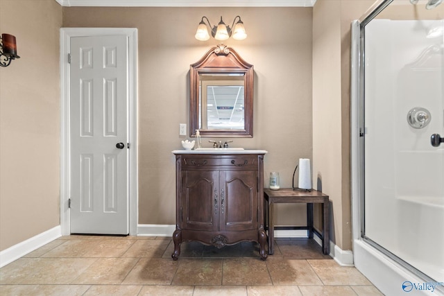 bathroom with a shower with door, tile patterned flooring, baseboards, and vanity