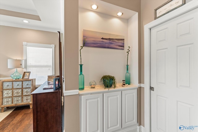 interior space featuring recessed lighting, crown molding, and wood finished floors