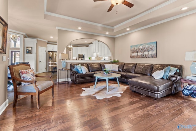 living room with a raised ceiling, dark wood finished floors, and recessed lighting