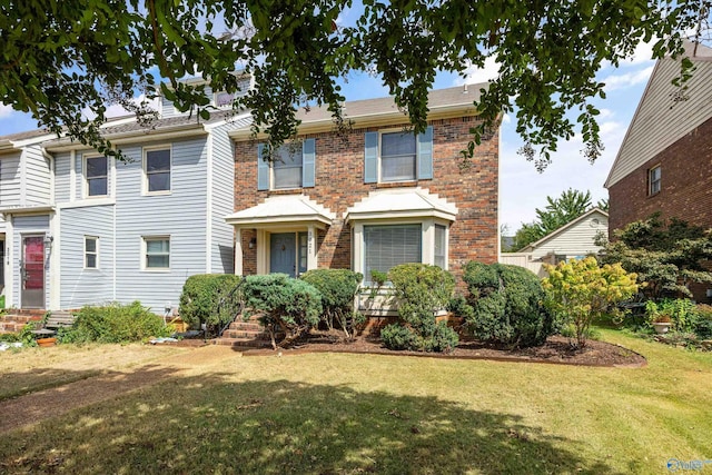 view of front of property with brick siding and a front yard