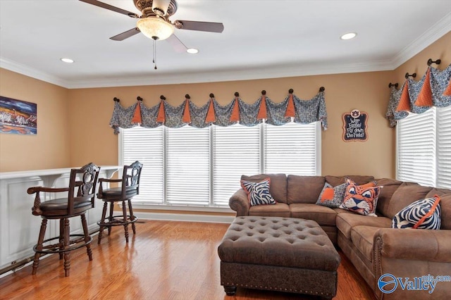 living area with light wood finished floors, a ceiling fan, recessed lighting, and crown molding