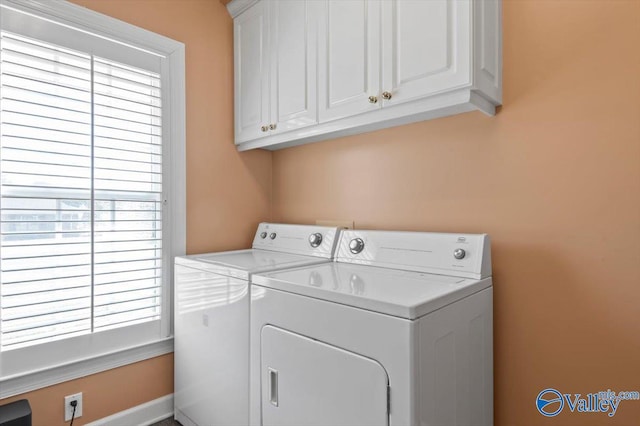 laundry area featuring washer and clothes dryer and cabinet space