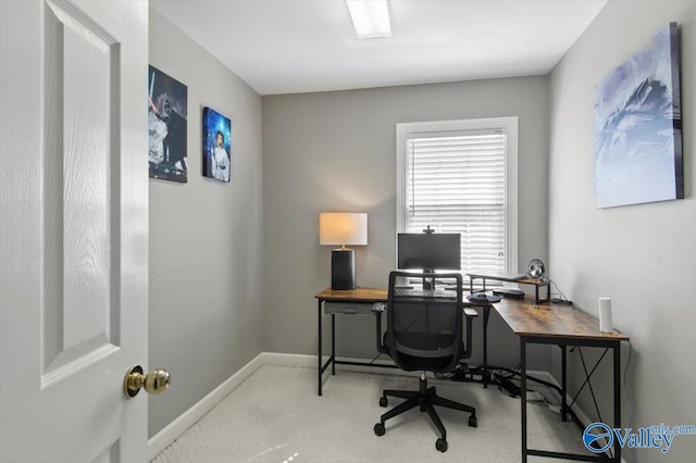 carpeted home office with baseboards