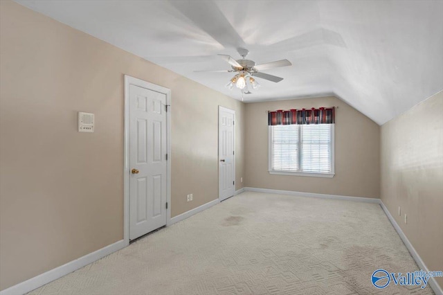 additional living space with lofted ceiling, a ceiling fan, carpet flooring, and baseboards